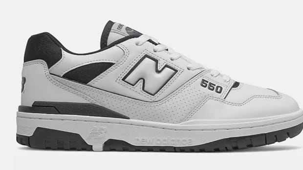 Side view of white and black New Balance shoe.